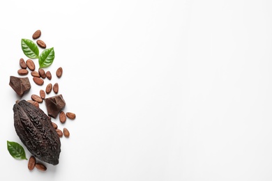 Photo of Cocoa pod with beans and chocolate pieces on white background, top view