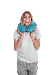 Photo of Happy young woman in pajamas with neck pillow on white background