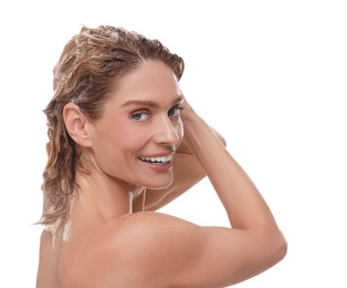 Photo of Beautiful happy woman washing hair on white background