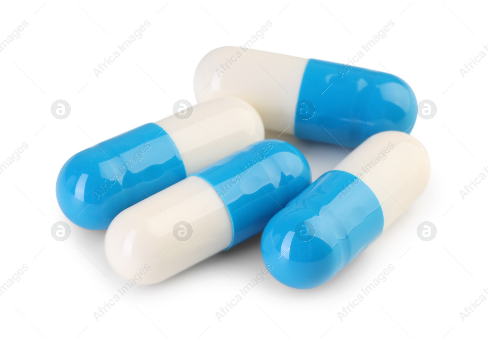 Photo of Antibiotic pills isolated on white. Medicinal treatment