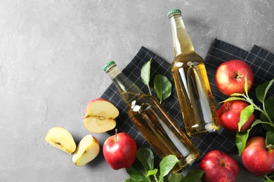 Flat lay composition with delicious apple cider on gray table, space for text