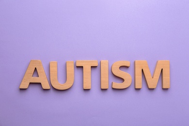 Word "Autism" on color background