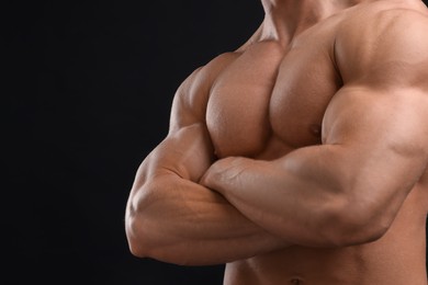 Muscular man on black background, closeup and space for text. Sexy body