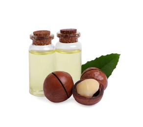Photo of Delicious organic Macadamia nuts, natural oil and green leaf isolated on white