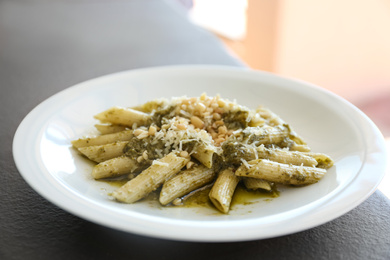 Delicious penne pasta with pesto sauce on plate