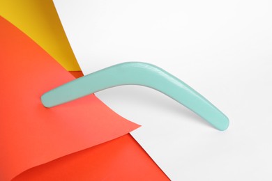 Photo of Turquoise boomerang on color background. Outdoor activity