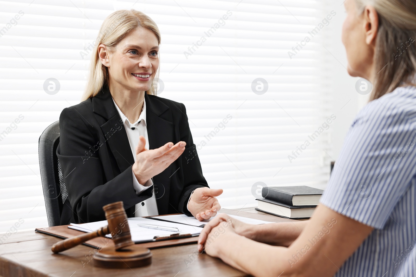 Photo of Senior woman having meeting with lawyer in office