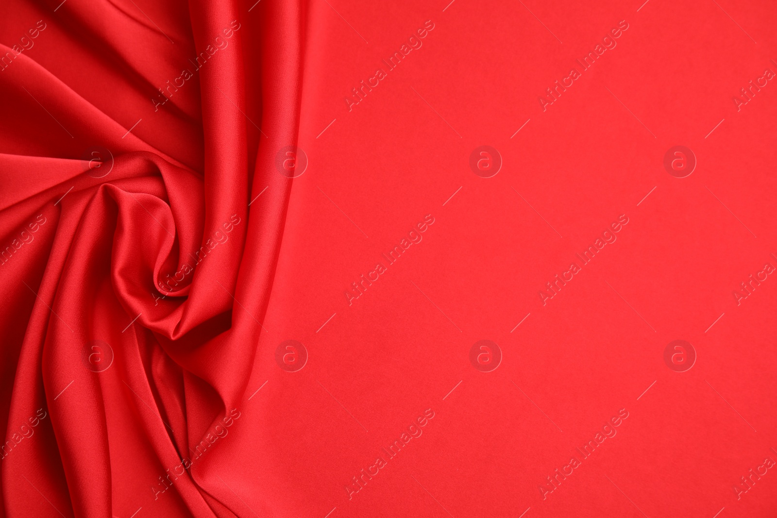 Photo of Texture of delicate red silk as background, top view