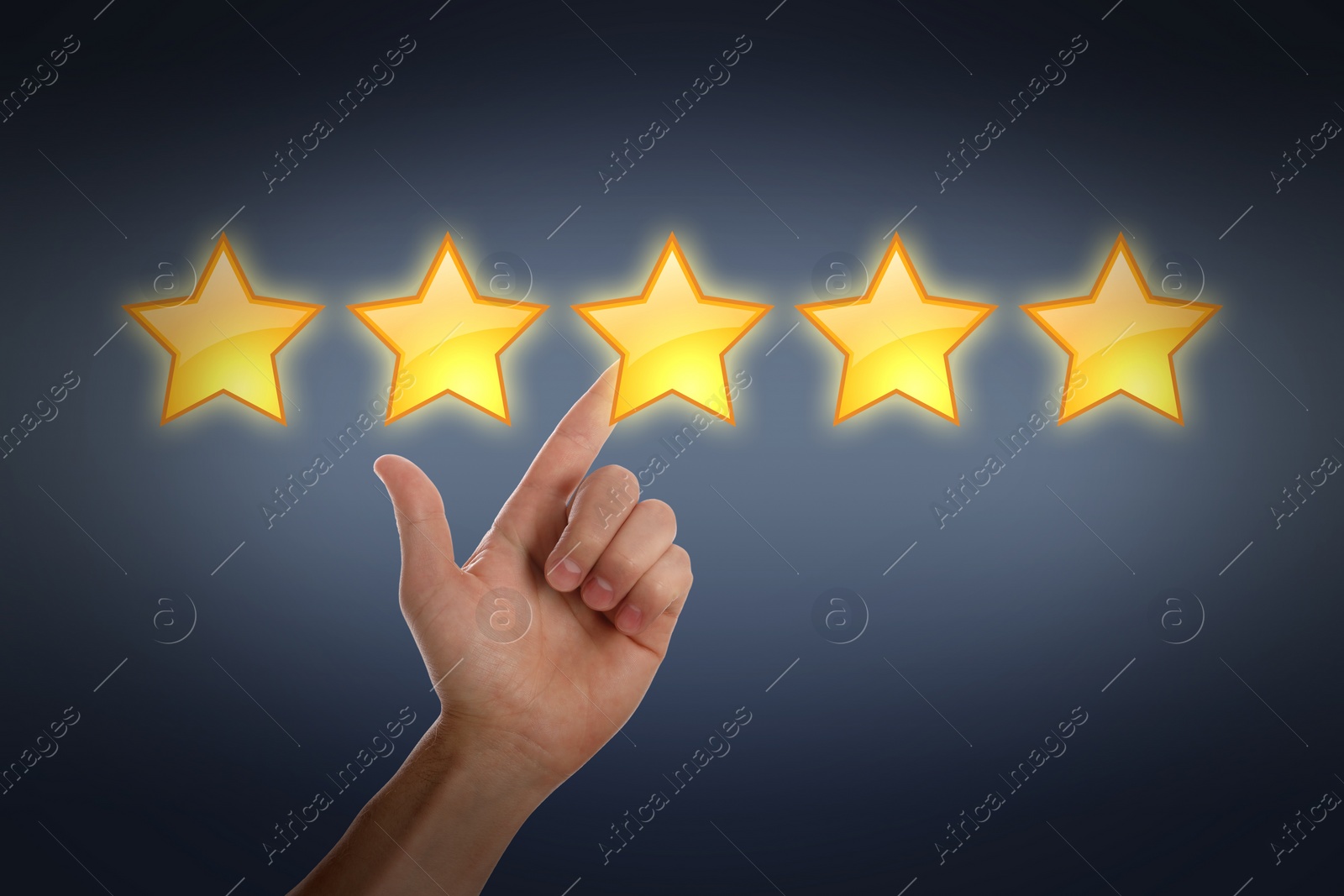 Image of Quality rating. Man pointing at stars on dark background, closeup