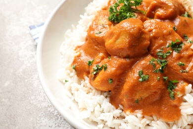 Delicious butter chicken with rice in bowl on table, closeup