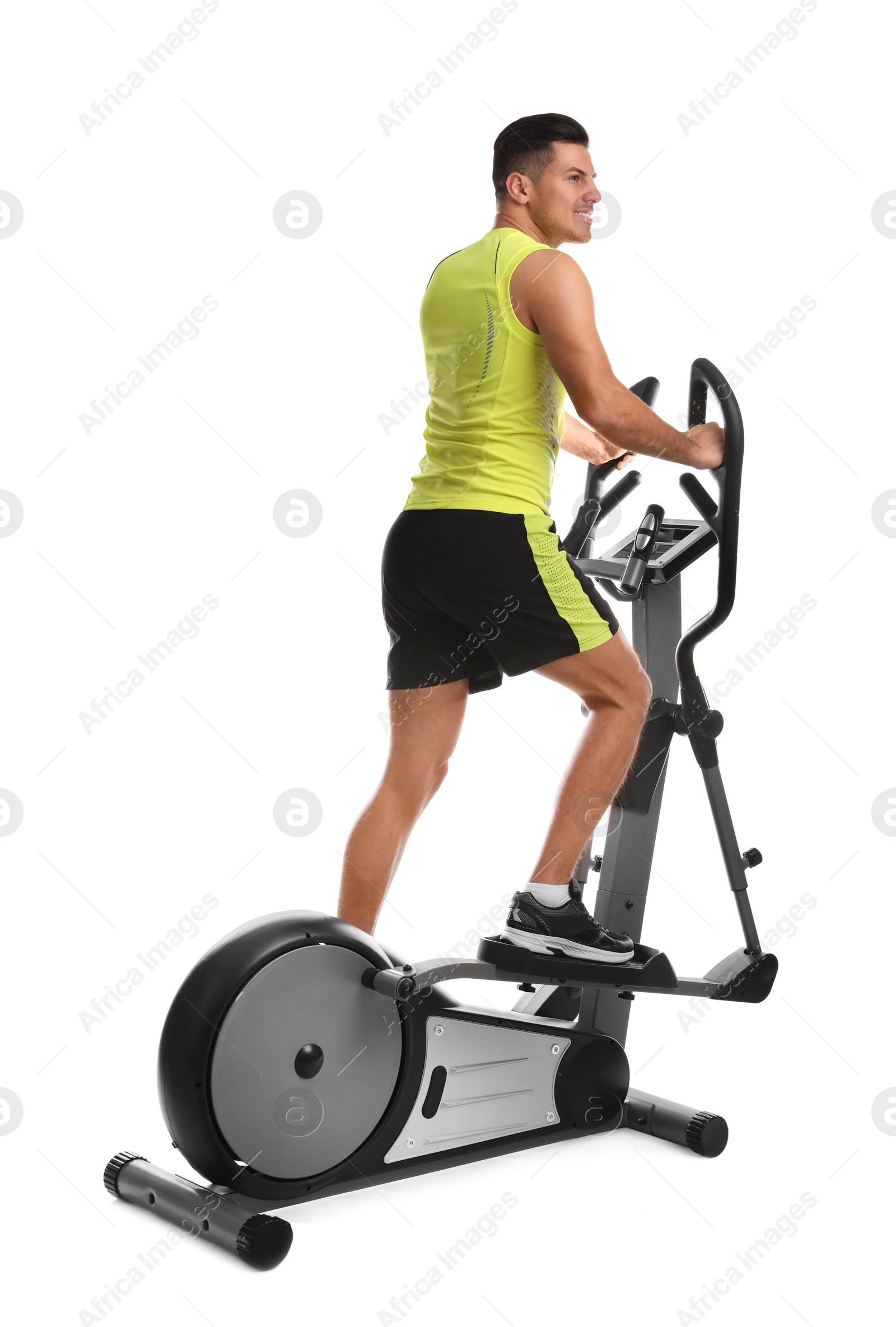 Photo of Man using modern elliptical machine on white background