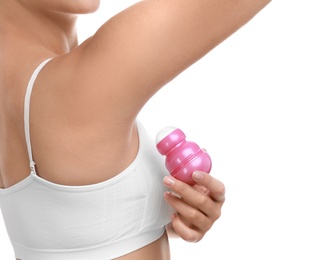 Young woman applying deodorant to armpit on white background, closeup