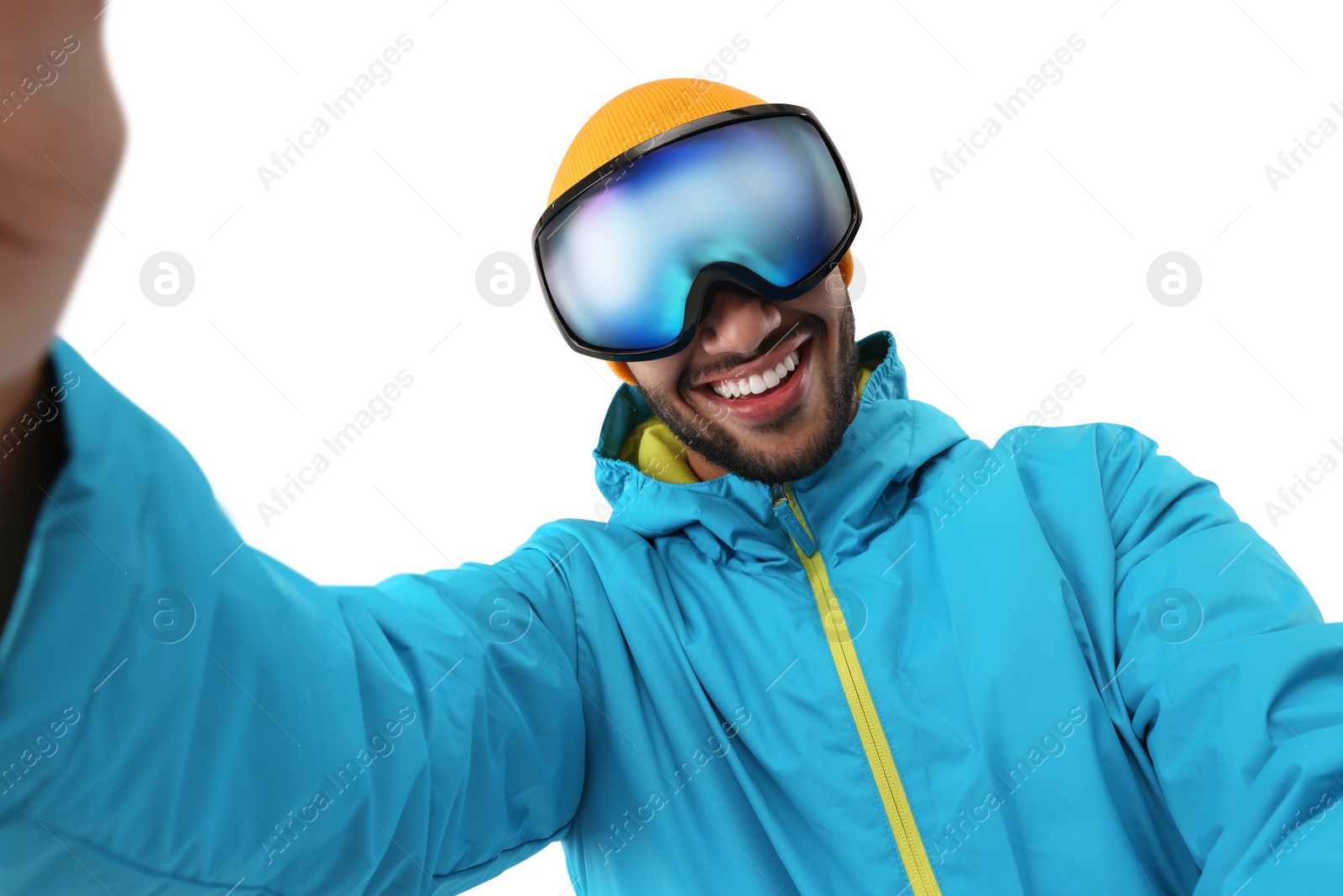 Photo of Smiling young man in ski goggles taking selfie on white background