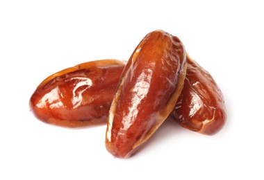 Photo of Three tasty sweet dried dates on white background