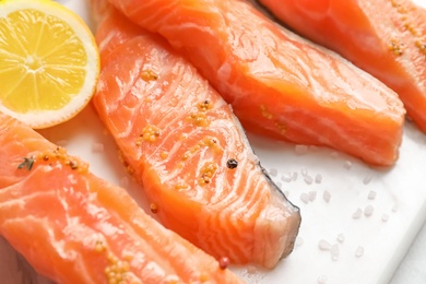 Fresh salmon with mustard and lemon, closeup