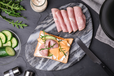 Photo of Delicious sandwich served on black table, flat lay