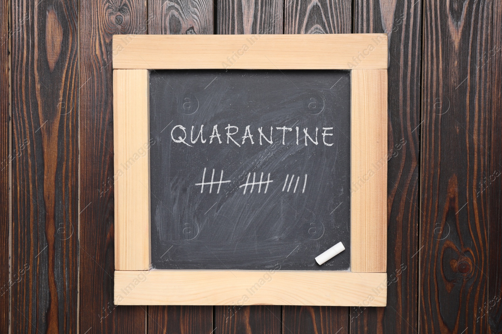 Image of Blackboard with chalk on wooden background, top view. Counting days of quarantine during coronavirus outbreak 