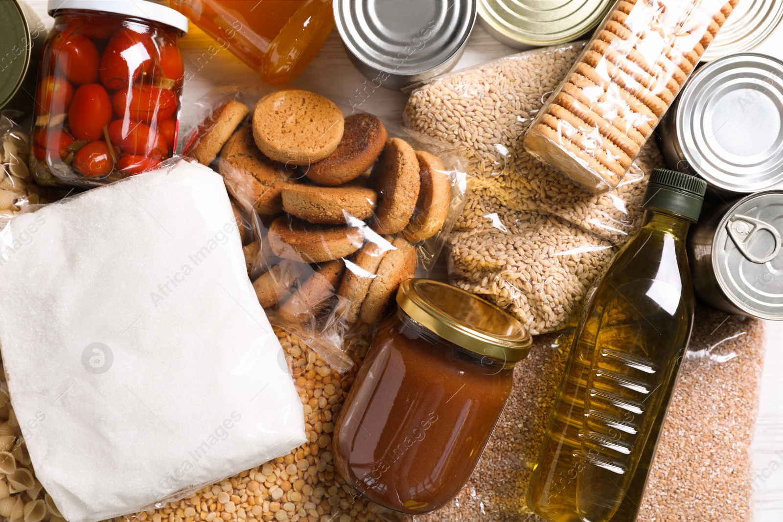 Photo of Different products on white table, flat lay. Food donation