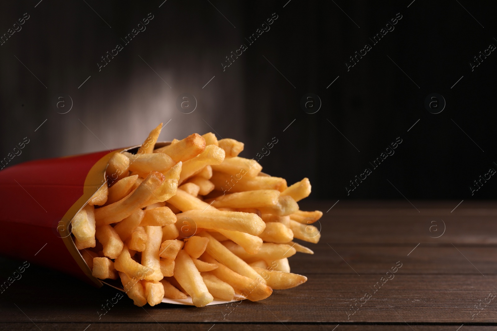 Photo of MYKOLAIV, UKRAINE - AUGUST 12, 2021: Big portion of McDonald's French fries on wooden table, closeup