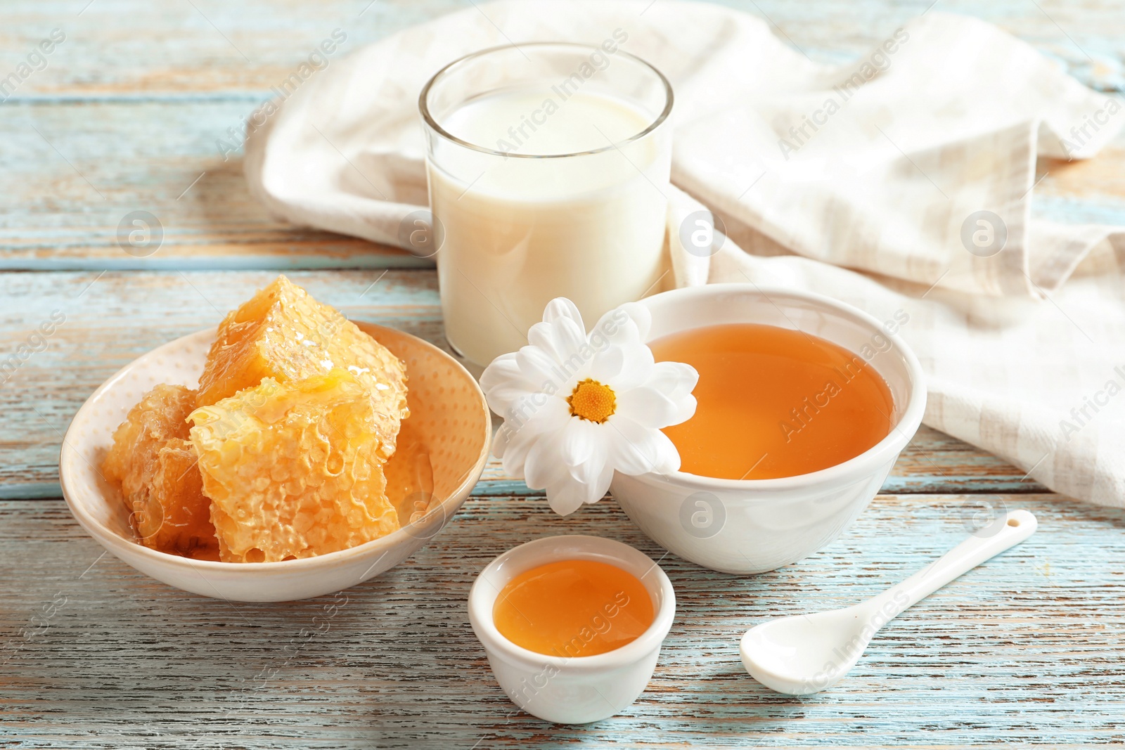 Photo of Beautiful composition with milk and honey on wooden background