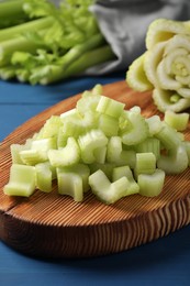 Fresh cut celery on blue wooden table, closeup