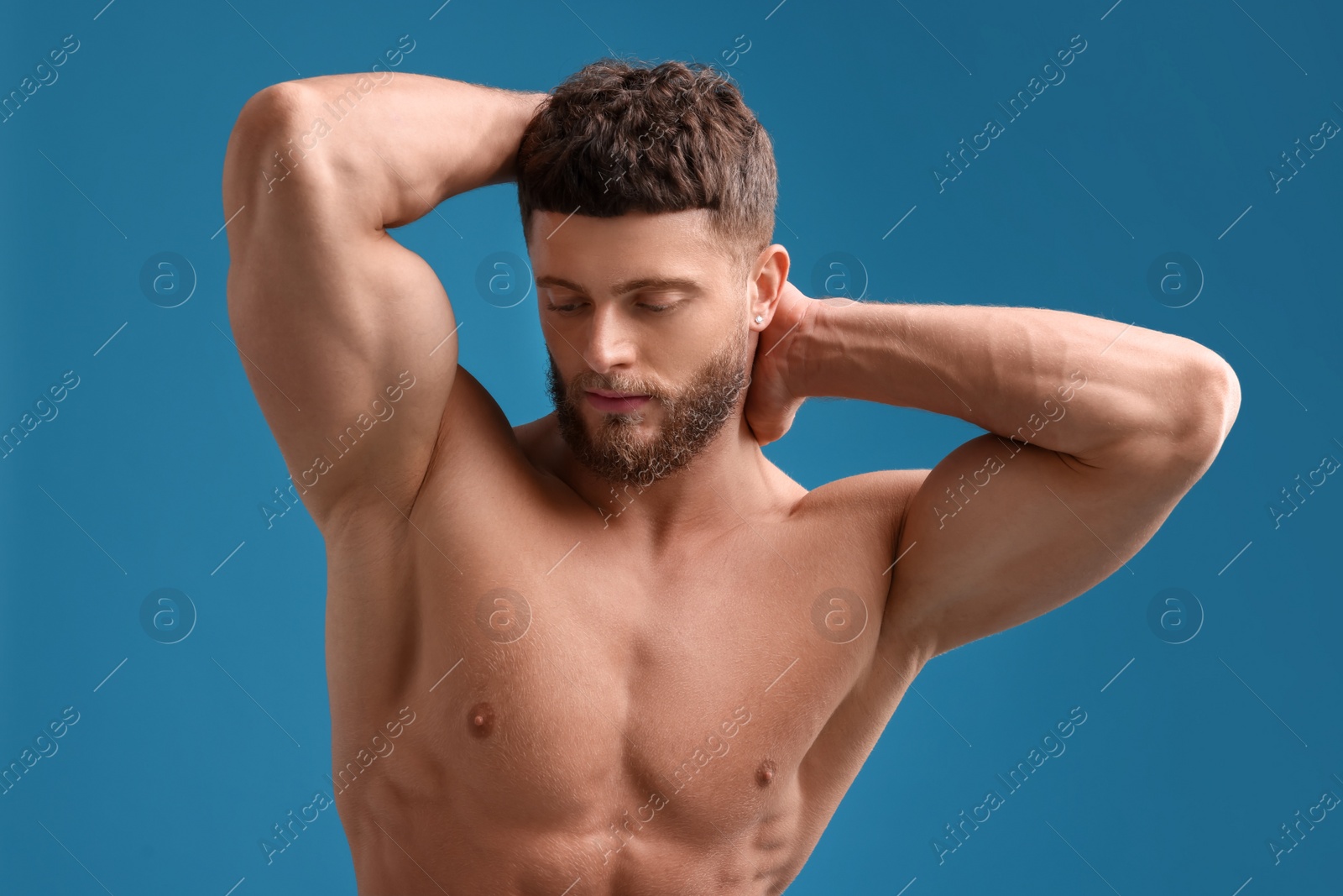 Photo of Handsome muscular man on light blue background. Sexy body