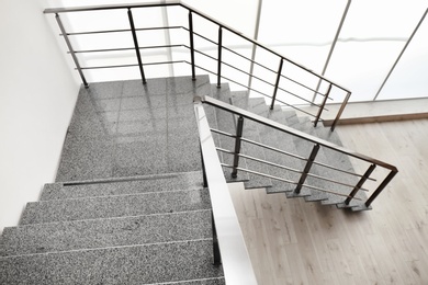 Photo of Stone stairs with metal railing indoors, view through CCTV camera