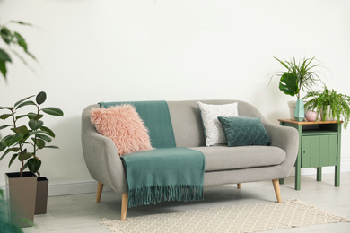 Soft pillows on grey sofa in living room