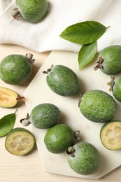 Photo of Flat lay composition with fresh green feijoa fruits on light table