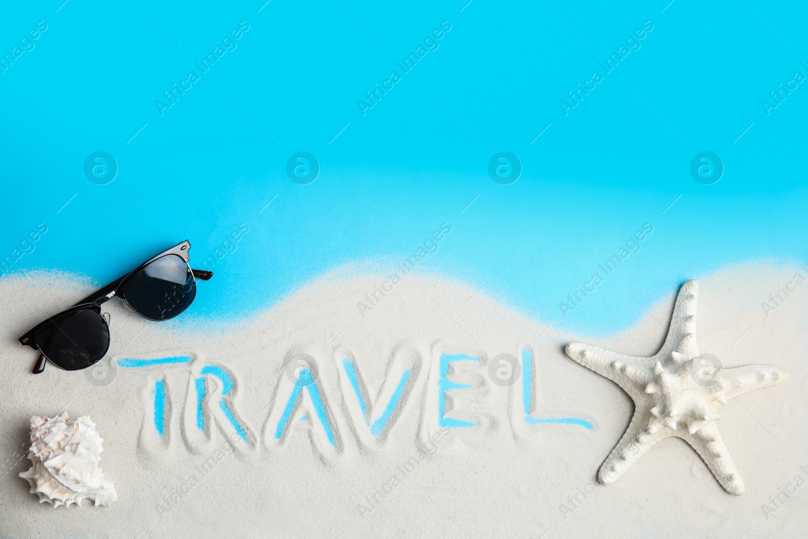 Photo of Flat lay composition with sand, sunglasses and word TRAVEL on color background, space for text. Tourist agency