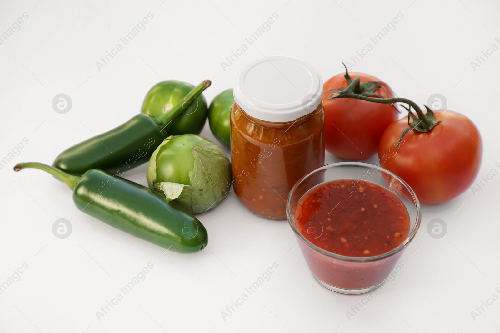 Photo of Delicious salsa sauce and ingredients on white background