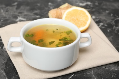 Photo of Dish with delicious hot broth on table. Cold treatment