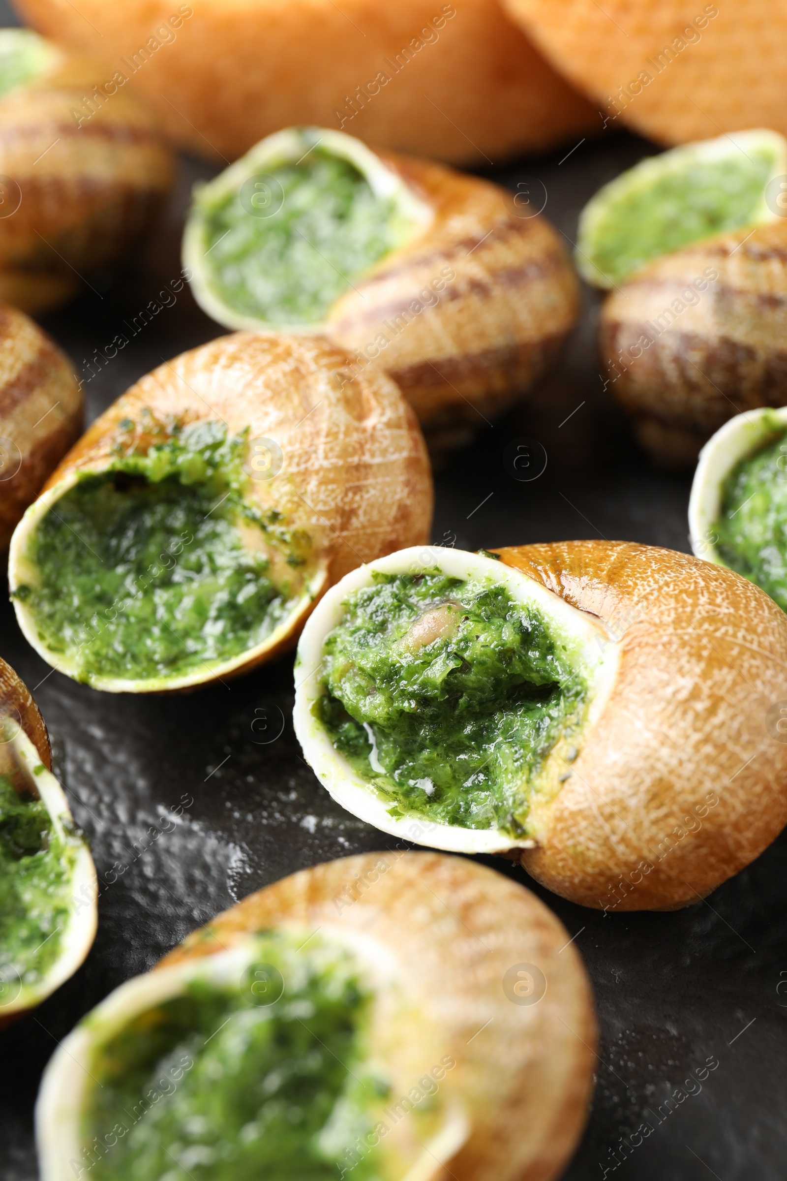 Photo of Delicious cooked snails on table, closeup view