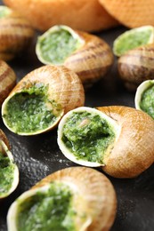 Photo of Delicious cooked snails on table, closeup view