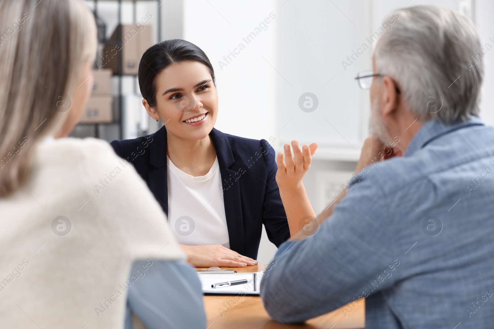 Photo of Notary consulting senior couple about Last Will and Testament in office