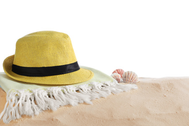 Photo of Folded towel, hat and shells on sand against white background, space for text. Beach objects