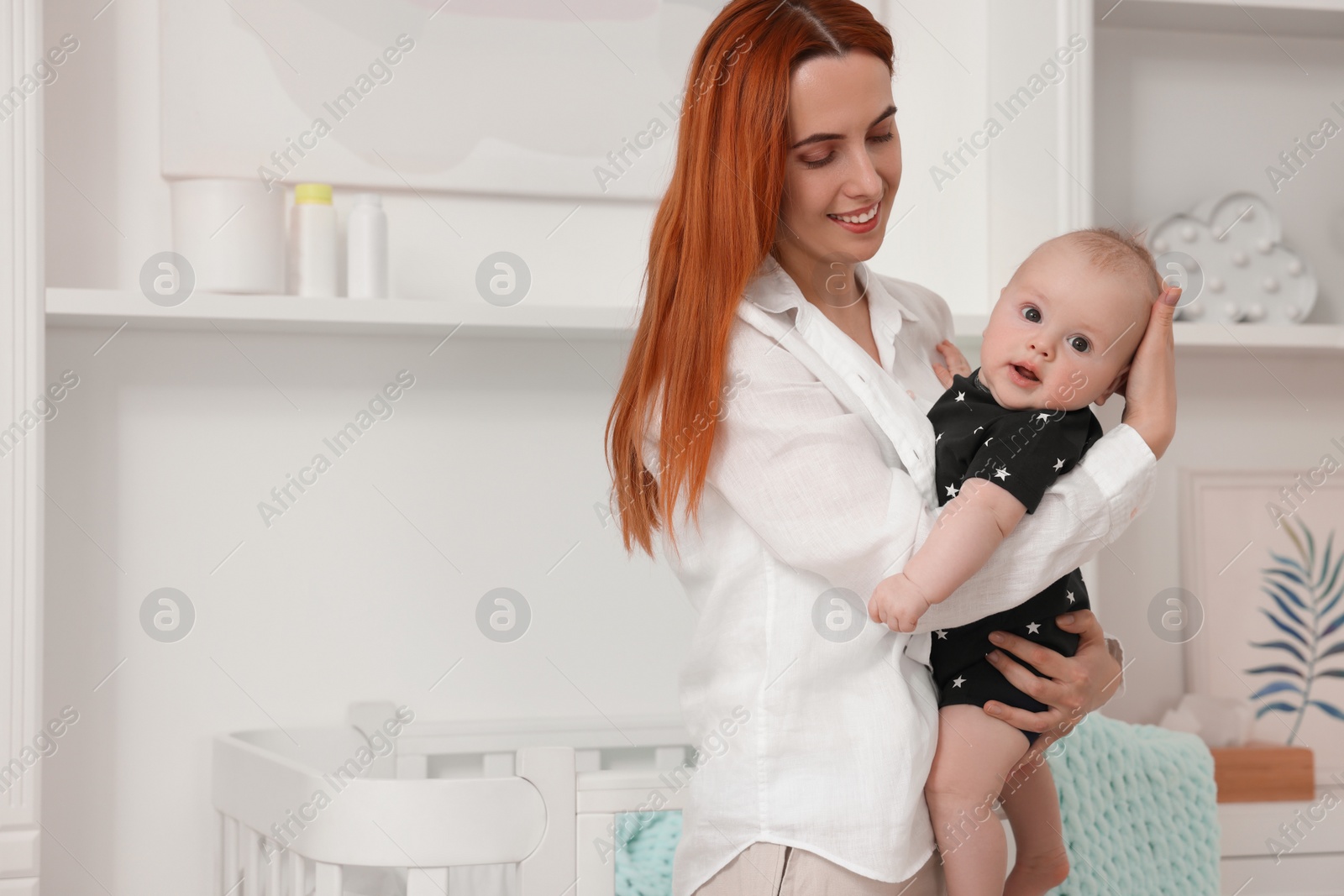 Photo of Mother with her cute baby at home, space for text