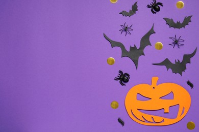 Photo of Flat lay composition with paper bats, pumpkin and spiders on purple background, space for text. Halloween decor