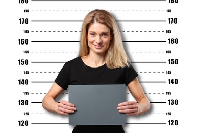 Image of Criminal mugshot. Arrested woman with blank card against height chart