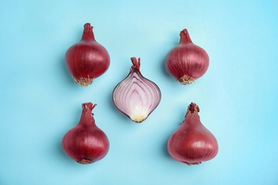 Beautiful composition with ripe red onions on color background