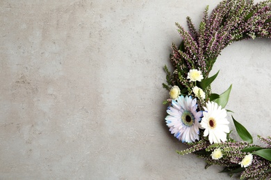 Photo of Beautiful autumnal wreath with heather flowers on light grey background, top view. Space for text