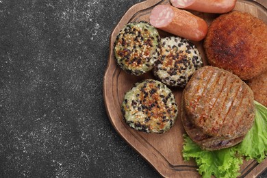 Different tasty vegan meat products on grey table, top view. Space for text