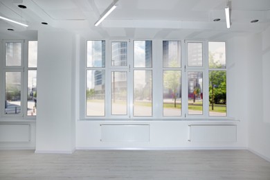 Photo of New empty room with clean windows and white wall