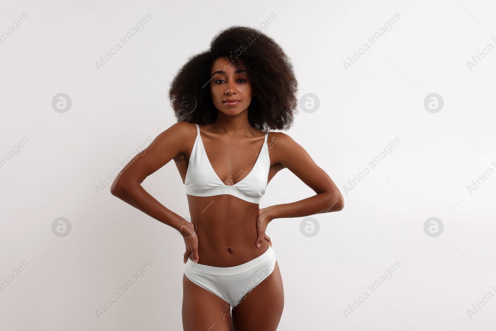 Photo of Beautiful woman in stylish bikini on white background