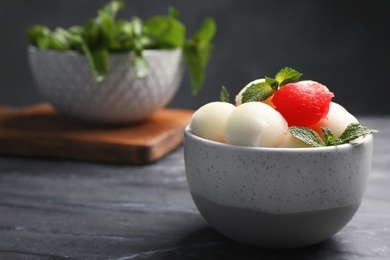 Bowl with melon and watermelon balls on table