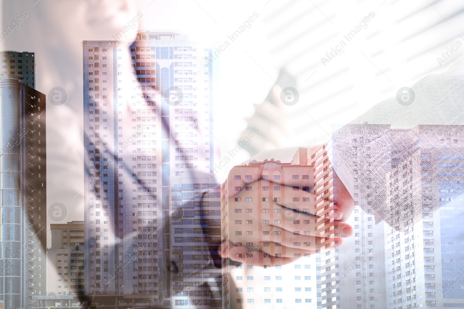 Image of Double exposure of cityscape and business people shaking hands in office, closeup. Team work 