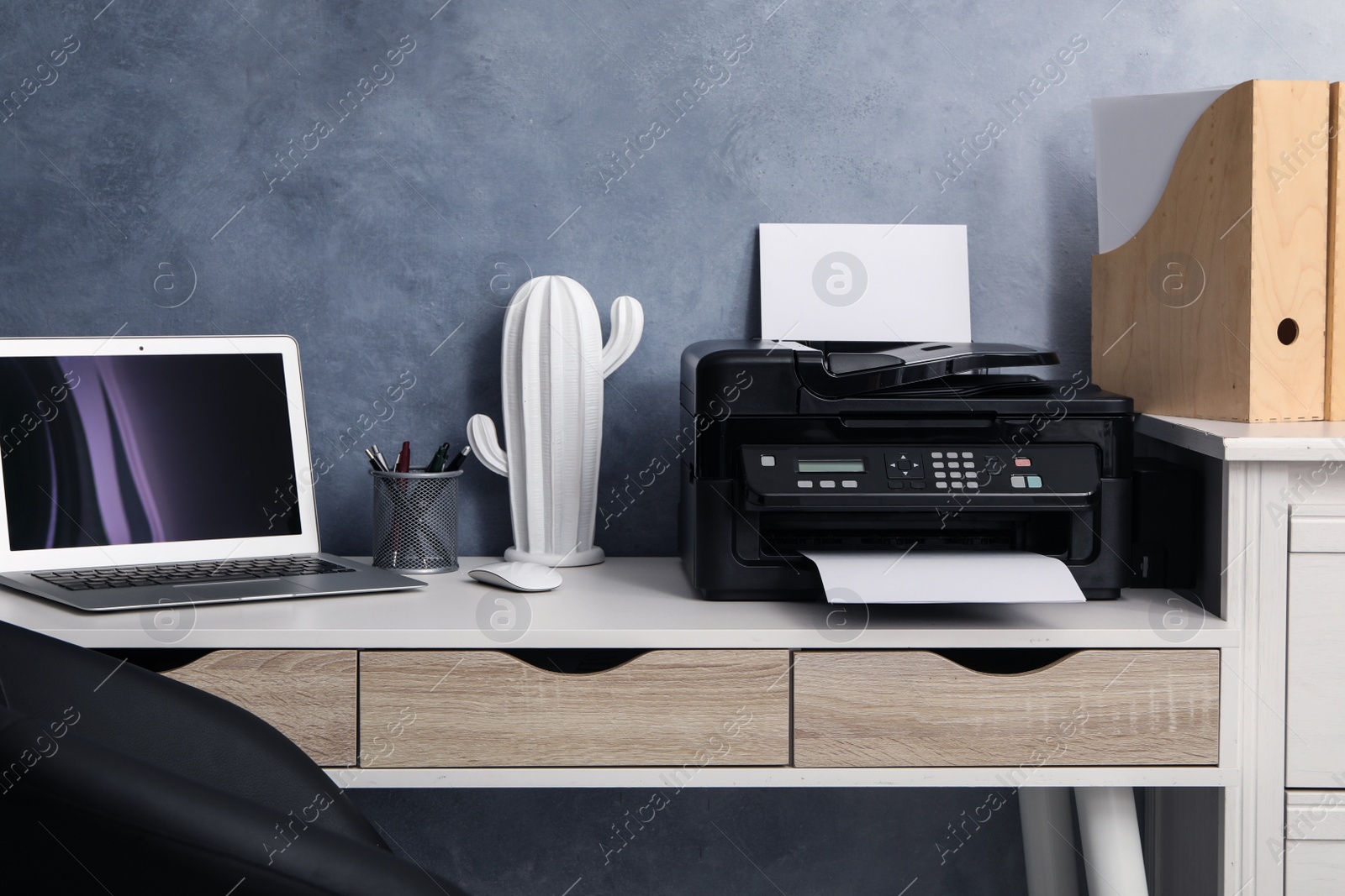 Photo of Modern printer and laptop on white table indoors