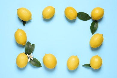 Photo of Frame of fresh ripe lemons on light blue background, flat lay. Space for text
