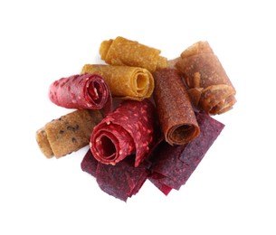 Delicious fruit leather rolls on white background, top view
