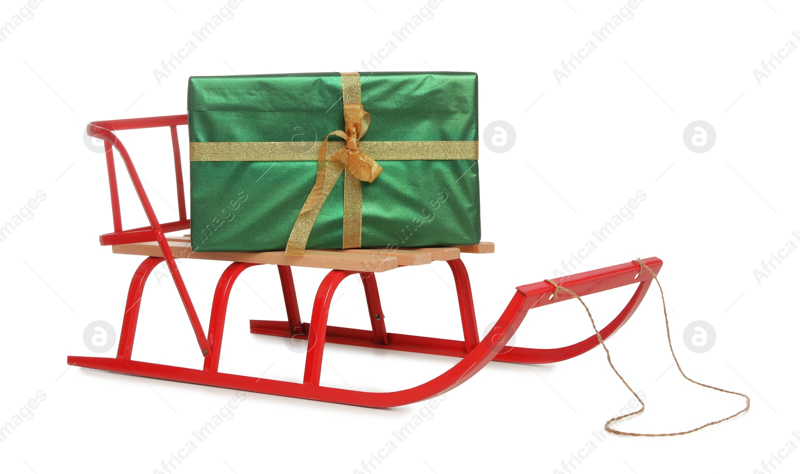 Photo of Sleigh with green gift box isolated on white